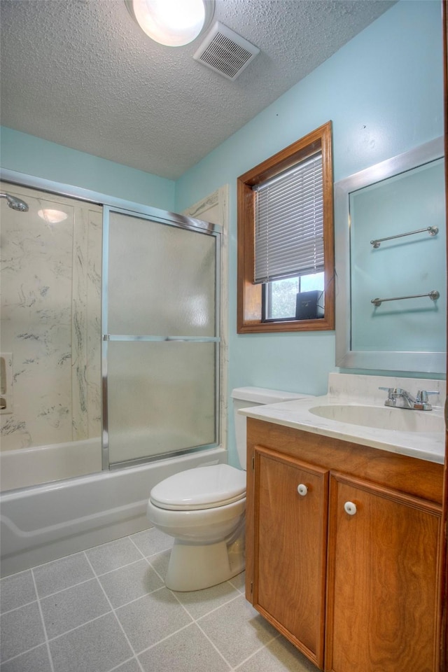 200 Cove View Dr, Trinity, TX 75862 - full bath with vanity, toilet, a textured ceiling, and bath / shower combo with glass door