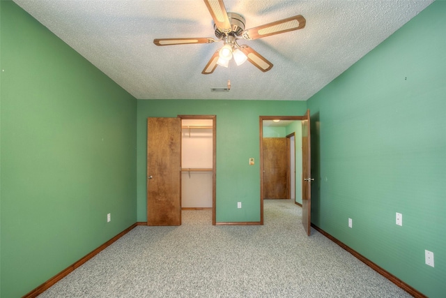 200 Cove View Dr, Trinity, TX 75862 - unfurnished bedroom with a textured ceiling, a spacious closet, baseboards, a closet, and carpet flooring