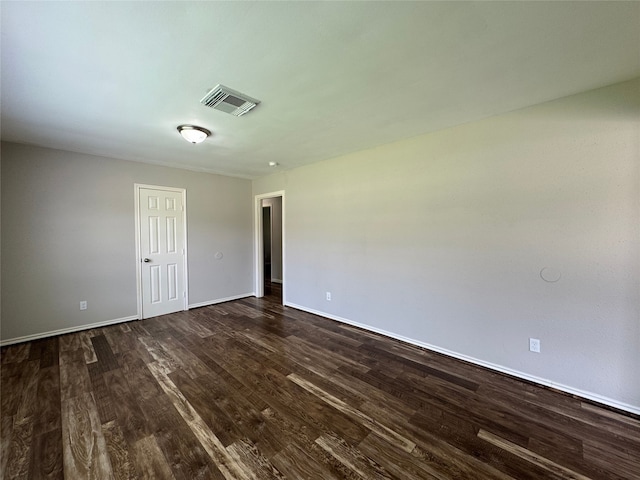 1206 Houston Ave, Pasadena, TX 77502 - spare room featuring dark wood-style floors and baseboards