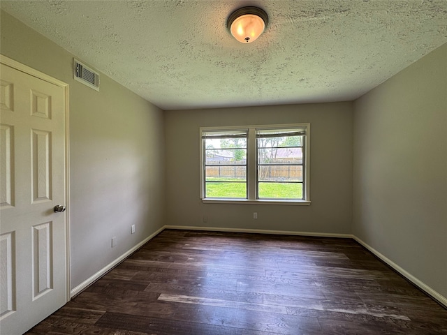 1206 Houston Ave, Pasadena, TX 77502 - spare room with dark wood-style flooring, a textured ceiling, and baseboards