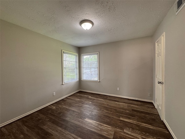1206 Houston Ave, Pasadena, TX 77502 - spare room with dark wood-style floors, a textured ceiling, and baseboards