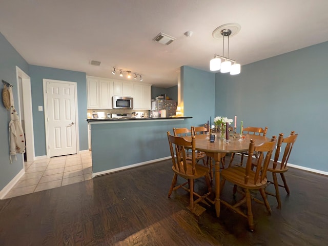 1919 Bailey St, Houston, TX 77006 - dining area with baseboards and light wood-type flooring