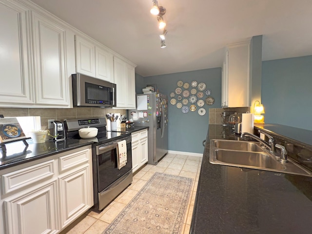 1919 Bailey St, Houston, TX 77006 - kitchen featuring appliances with stainless steel finishes, a sink, tasteful backsplash, and dark countertops