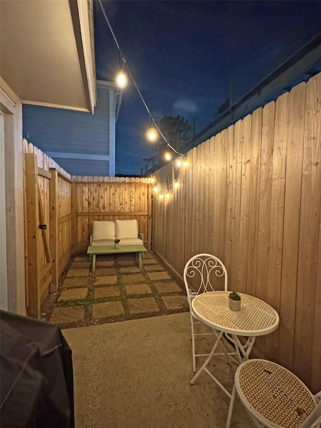 1919 Bailey St, Houston, TX 77006 - patio at night with a patio area and a fenced backyard
