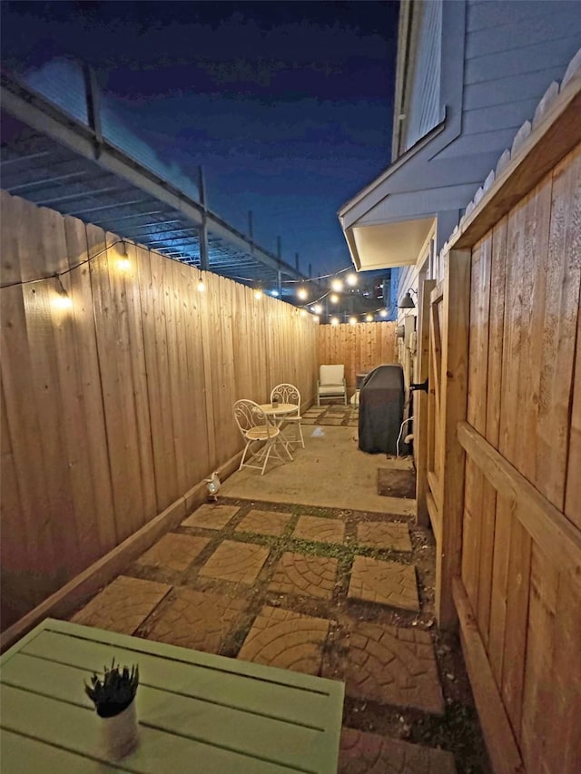 1919 Bailey St, Houston, TX 77006 - patio at twilight featuring a patio area, a fenced backyard, and area for grilling
