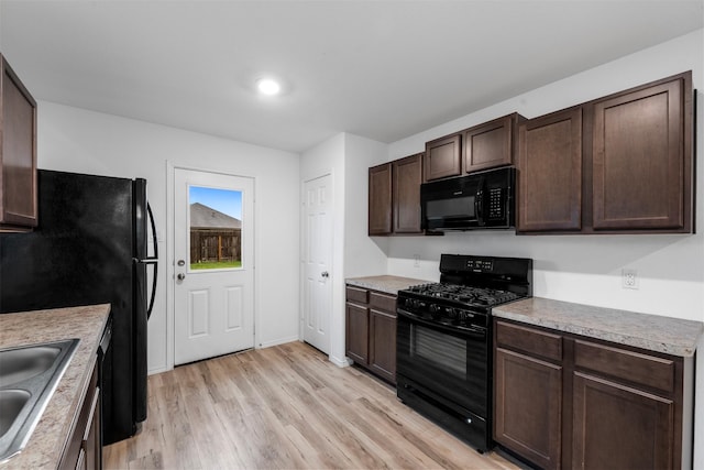 4331 Cedar Elm St, Baytown, TX 77521 - kitchen featuring black appliances, dark brown cabinets, light wood-style floors, and light countertops