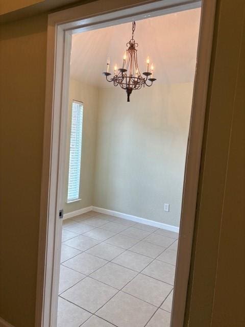 19119 Field Cottage Ln, Richmond, TX 77407 - spare room with a chandelier, light tile patterned flooring, and baseboards