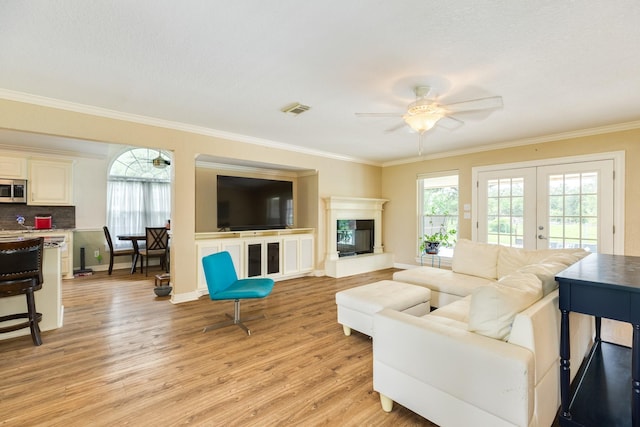 208 Fawn Trl, Lake Jackson, TX 77566 - living area with a ceiling fan, light wood-style floors, plenty of natural light, crown molding, and french doors