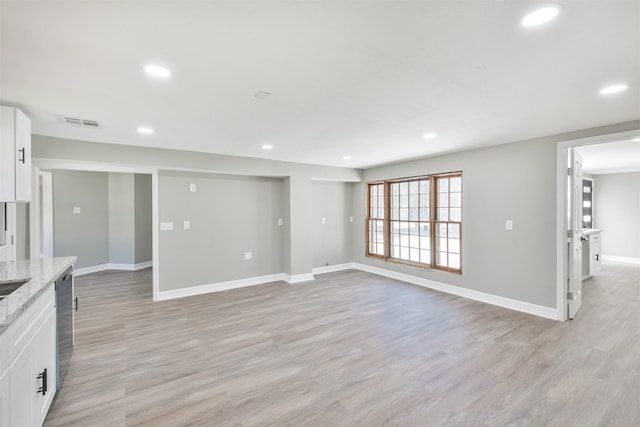 5419 Palmer St, Houston, TX 77004 - unfurnished living room featuring baseboards, light wood-type flooring, and recessed lighting