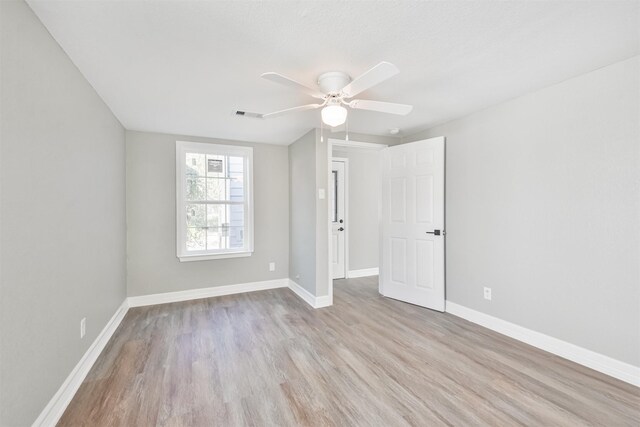 5419 Palmer St, Houston, TX 77004 - spare room featuring wood finished floors, a ceiling fan, and baseboards