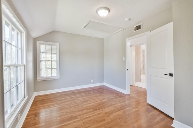 5419 Palmer St, Houston, TX 77004 - empty room featuring attic access, light wood finished floors, vaulted ceiling, and baseboards