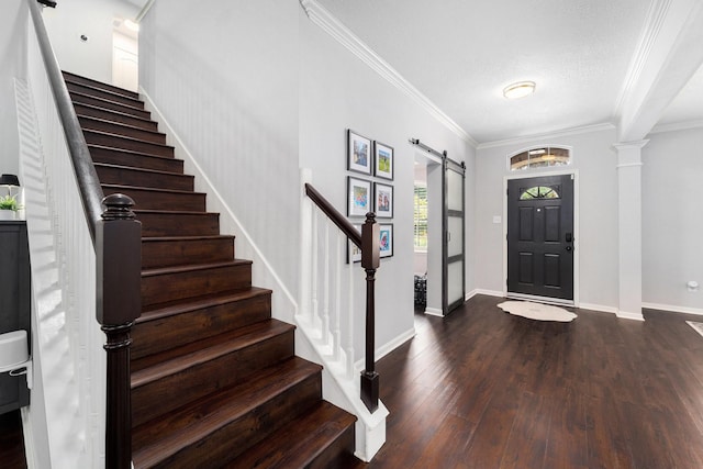 31215 Rainwood Park Ln, Spring, TX 77386 - entrance foyer with stairway, a barn door, dark wood-style flooring, crown molding, and baseboards
