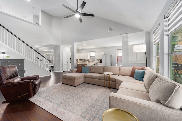 31215 Rainwood Park Ln, Spring, TX 77386 - living room with decorative columns, stairs, ceiling fan, dark wood-style floors, and high vaulted ceiling