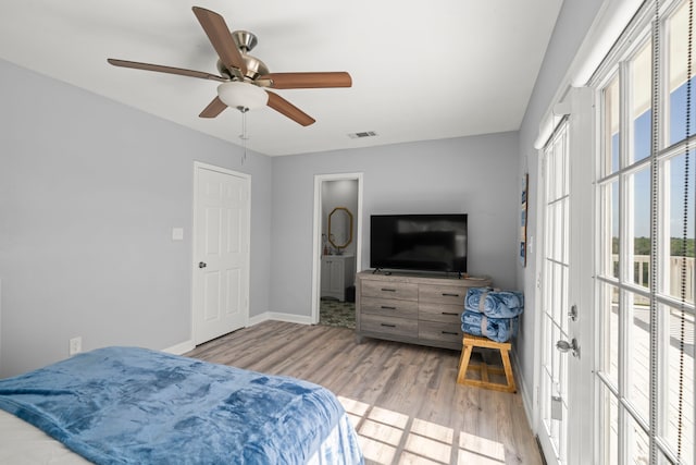3582 County Road 476, Palacios, TX 77465 - bedroom with multiple windows, light wood-type flooring, and baseboards