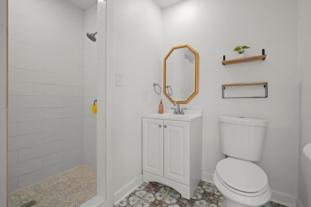 3582 County Road 476, Palacios, TX 77465 - bathroom with toilet, tiled shower, baseboards, vanity, and tile patterned flooring