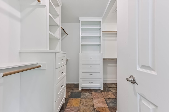 406 Westwood Dr, Friendswood, TX 77546 - walk in closet featuring dark stone finish floors