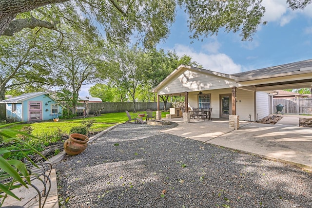 406 Westwood Dr, Friendswood, TX 77546 - back of property with an outbuilding and a patio area