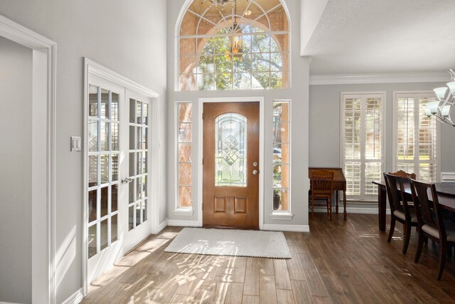 16022 Winchmore Hill Dr, Spring, TX 77379 - entryway featuring a chandelier, hardwood / wood-style flooring, plenty of natural light, ornamental molding, and french doors