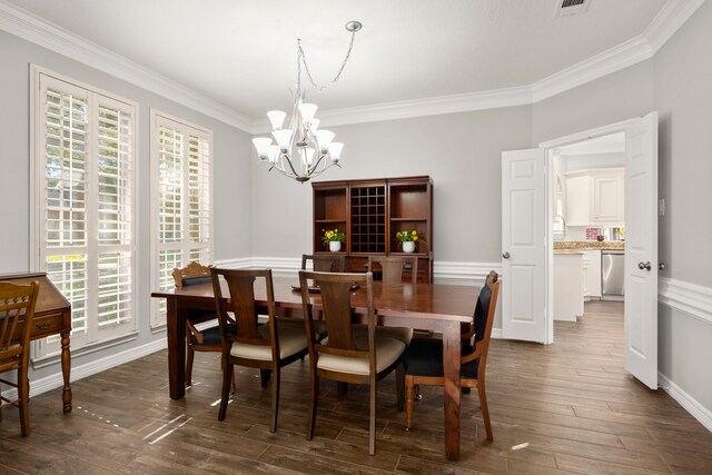 16022 Winchmore Hill Dr, Spring, TX 77379 - dining room with a chandelier, crown molding, and dark wood-type flooring