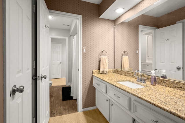 16022 Winchmore Hill Dr, Spring, TX 77379 - full bathroom featuring vanity, toilet, wood finished floors, and baseboards