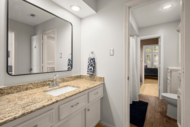16022 Winchmore Hill Dr, Spring, TX 77379 - full bathroom featuring vanity, wood finished floors, toilet, and recessed lighting