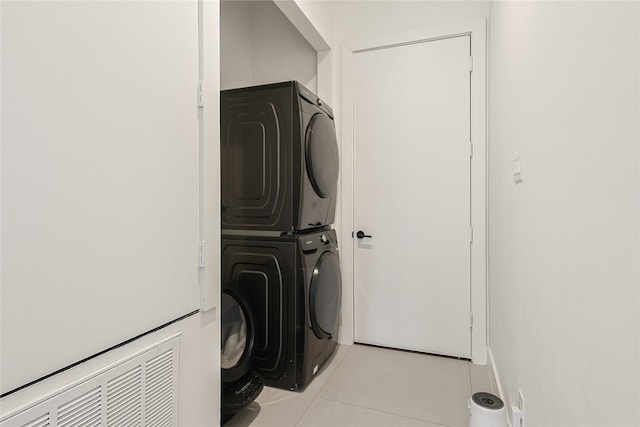 1550 Ashway St, Conroe, TX 77385 - laundry area featuring stacked washer / dryer and light tile patterned flooring