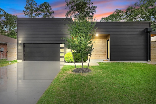 1550 Ashway St, Conroe, TX 77385 - contemporary home with concrete driveway, a front lawn, and a garage