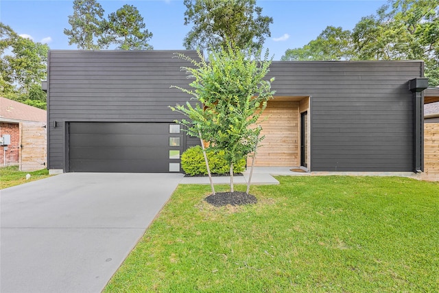 1550 Ashway St, Conroe, TX 77385 - view of front of property with a garage, a front lawn, and driveway