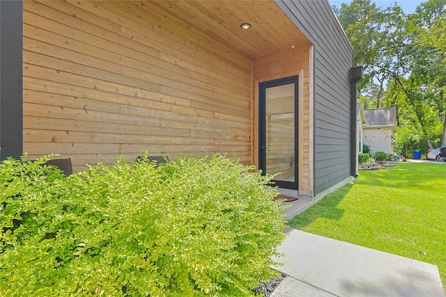 1550 Ashway St, Conroe, TX 77385 - view of exterior entry featuring a lawn