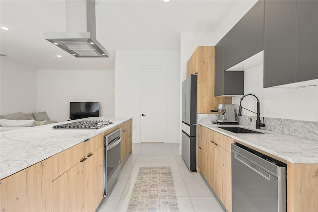 1550 Ashway St, Conroe, TX 77385 - kitchen with stainless steel appliances, ventilation hood, modern cabinets, open floor plan, and light brown cabinets