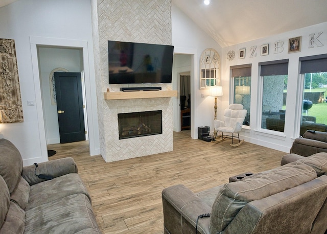 455 Green Meadows Dr, West Columbia, TX 77486 - living area with a tiled fireplace, high vaulted ceiling, wood finished floors, and baseboards