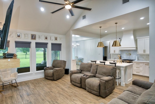 455 Green Meadows Dr, West Columbia, TX 77486 - living area with high vaulted ceiling, light wood-style floors, a chandelier, recessed lighting, and ceiling fan