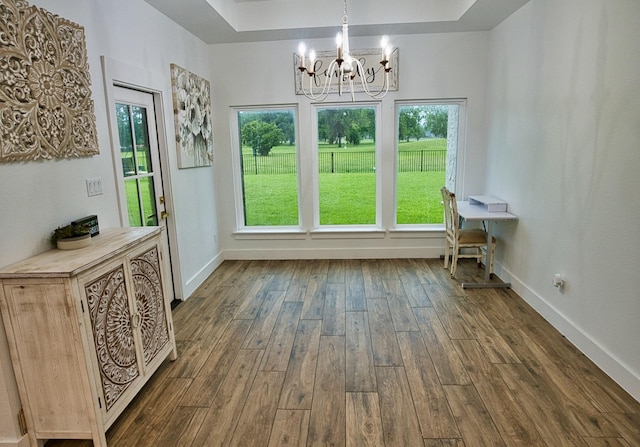 455 Green Meadows Dr, West Columbia, TX 77486 - unfurnished dining area featuring a chandelier, dark wood finished floors, healthy amount of natural light, and baseboards