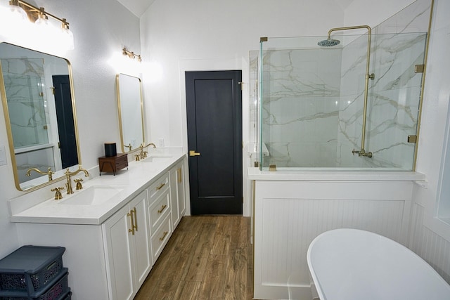 455 Green Meadows Dr, West Columbia, TX 77486 - bathroom featuring a freestanding tub, wood finished floors, a marble finish shower, and double vanity