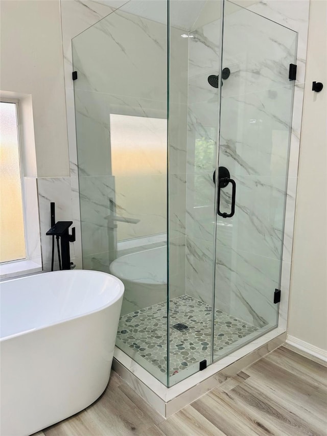 21227 River Knoll Ln, Katy, TX 77449 - bathroom featuring a freestanding bath, a marble finish shower, and wood finished floors