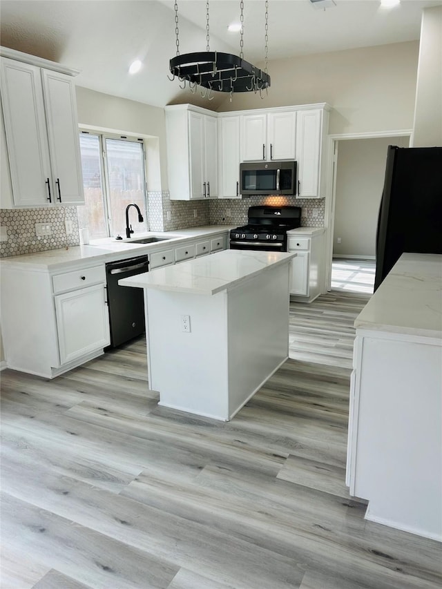21227 River Knoll Ln, Katy, TX 77449 - kitchen with black appliances, a sink, white cabinets, and backsplash