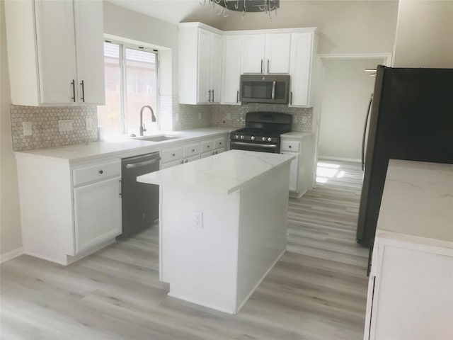 21227 River Knoll Ln, Katy, TX 77449 - kitchen featuring appliances with stainless steel finishes, a sink, light wood-style flooring, white cabinetry, and decorative backsplash