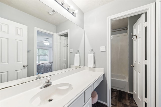 31415 Rigel Ct, Tomball, TX 77375 - ensuite bathroom with vanity, wood finished floors, shower / bath combination, a textured ceiling, and baseboards