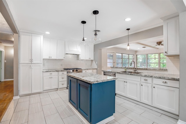 606 N Main St, Dayton, TX 77535 - kitchen with a sink, custom range hood, white cabinetry, a center island, and decorative backsplash