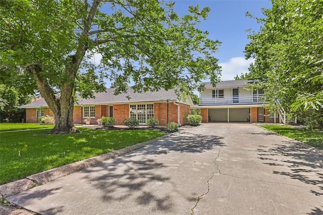 606 N Main St, Dayton, TX 77535 - view of front of property with brick siding, asphalt driveway, an attached garage, and a front lawn
