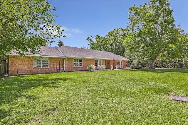606 N Main St, Dayton, TX 77535 - ranch-style house with a front yard and brick siding