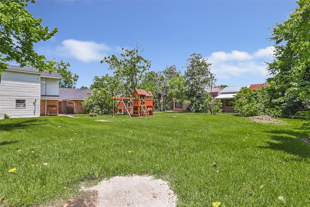 606 N Main St, Dayton, TX 77535 - view of grassy yard featuring a playground