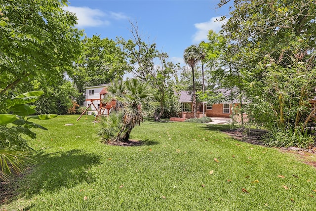 606 N Main St, Dayton, TX 77535 - view of green lawn with a playground