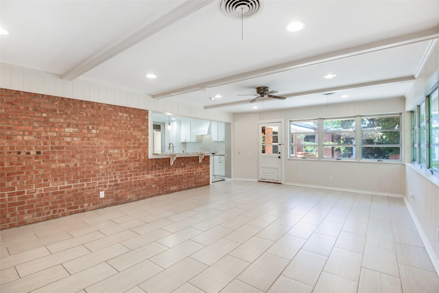 606 N Main St, Dayton, TX 77535 - unfurnished living room featuring brick wall, beamed ceiling, a ceiling fan, and recessed lighting