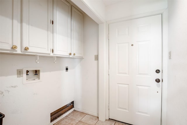 606 N Main St, Dayton, TX 77535 - washroom with electric dryer hookup, cabinet space, light tile patterned flooring, and hookup for a washing machine