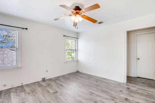 606 N Main St, Dayton, TX 77535 - empty room with wood finished floors, a ceiling fan, and baseboards