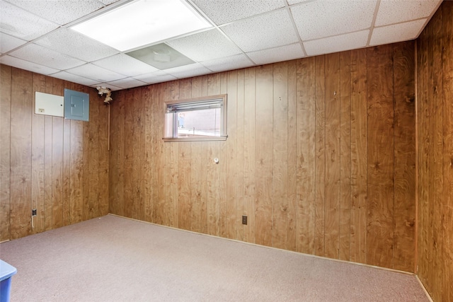 606 N Main St, Dayton, TX 77535 - basement featuring a drop ceiling, electric panel, wooden walls, and carpet floors