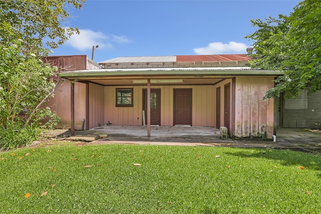 606 N Main St, Dayton, TX 77535 - rear view of property featuring a lawn and metal roof