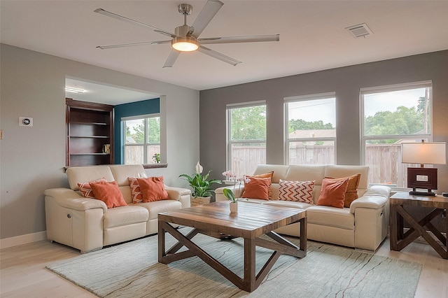 15251 Weeping Cedar Ln, Houston, TX 77084 - living area with light wood-style floors, ceiling fan, and baseboards