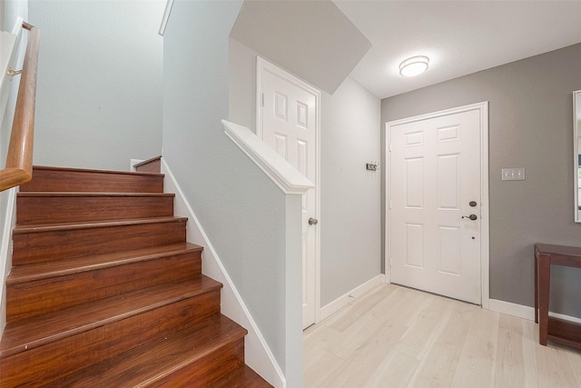 15251 Weeping Cedar Ln, Houston, TX 77084 - foyer with light wood finished floors, baseboards, and stairway